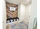 Stylish mud room with wood accent wall, bench, storage baskets, and a decorative rug for a welcoming entrance at 2539 Auburn Ridge Dr, Apopka, FL 32712
