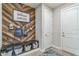 Cozy mudroom boasts custom wooden accent wall with storage bench and cubbies for organization at 2539 Auburn Ridge Dr, Apopka, FL 32712