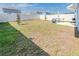 Large backyard featuring a firepit, patio set, fence, and ample space for recreation at 26271 Feathergrass Cir, Leesburg, FL 34748