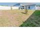 Spacious backyard features a patio with seating, fire pit, fenced yard, and lush grass at 26271 Feathergrass Cir, Leesburg, FL 34748