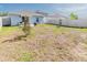 View of the backyard with a patio, grill, and fenced perimeter for outdoor living at 26271 Feathergrass Cir, Leesburg, FL 34748
