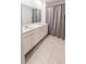 Bathroom featuring double sinks and shower with a grey patterned curtain at 26271 Feathergrass Cir, Leesburg, FL 34748