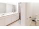 Modern bathroom has double sinks and a shower with stylish curtain at 26271 Feathergrass Cir, Leesburg, FL 34748