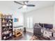 Office/bedroom featuring stylish dark wood floors, ceiling fan, and window with natural light at 26271 Feathergrass Cir, Leesburg, FL 34748