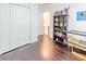 Office/bedroom features stylish dark wood floors and a closet for storage at 26271 Feathergrass Cir, Leesburg, FL 34748