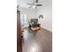 Office/bedroom featuring stylish dark wood floors, ceiling fan, and window with light at 26271 Feathergrass Cir, Leesburg, FL 34748