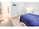 Bright bedroom features closet, light wood floors, and entry to another room at 26271 Feathergrass Cir, Leesburg, FL 34748