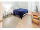 Bright bedroom features stylish wood floors, a side table, and plenty of natural light at 26271 Feathergrass Cir, Leesburg, FL 34748