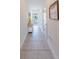 Inviting entryway with tiled floors, a decorative console table, and a view of the street at 26271 Feathergrass Cir, Leesburg, FL 34748