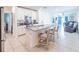 Modern open-concept kitchen with a large island, stainless steel appliances, and views of the adjacent living space at 26271 Feathergrass Cir, Leesburg, FL 34748