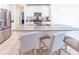 Modern open-concept kitchen with a large island, stainless steel appliances, and a breakfast bar with seating at 26271 Feathergrass Cir, Leesburg, FL 34748