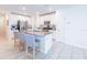Bright kitchen features a large island with seating and stainless steel appliances at 26271 Feathergrass Cir, Leesburg, FL 34748