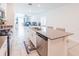 Modern open-concept kitchen with a large island, stainless steel appliances, and views of the adjacent living space at 26271 Feathergrass Cir, Leesburg, FL 34748