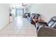 Relaxing living room has a ceiling fan, tile floors, and sliding glass door to the backyard at 26271 Feathergrass Cir, Leesburg, FL 34748