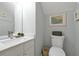 Cozy bathroom features a toilet and a vanity with a white countertop at 2648 Daulby St, Kissimmee, FL 34747