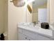 Neutral toned bathroom with quartz countertops and gold leaf decor at 2648 Daulby St, Kissimmee, FL 34747
