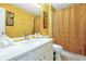 Bright bathroom featuring a quartz countertop vanity, mirror, and decorative artwork at 2648 Daulby St, Kissimmee, FL 34747