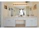 Bright bathroom features a double sink with white cabinets and granite countertops at 2648 Daulby St, Kissimmee, FL 34747