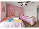 Charming bedroom featuring princess-themed decor and two cozy twin beds at 2648 Daulby St, Kissimmee, FL 34747
