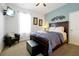Bedroom features a cozy sitting chair and a bed with swan-shaped towels at 2648 Daulby St, Kissimmee, FL 34747