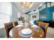 Formal dining room with seating for six next to an open kitchen and a large window at 2648 Daulby St, Kissimmee, FL 34747