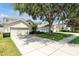 Beautiful single-Gathering home showcases manicured lawns, mature landscaping, and a spacious driveway at 2648 Daulby St, Kissimmee, FL 34747