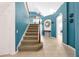 Inviting home entry with a staircase, archway, and stylish decor on tile flooring at 2648 Daulby St, Kissimmee, FL 34747