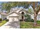Beautiful two-story home with a well-manicured lawn and two-car garage at 2648 Daulby St, Kissimmee, FL 34747