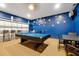 Game room with pool table, seating, and blue brick-style accent wall at 2648 Daulby St, Kissimmee, FL 34747