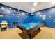Recreation room with a pool table, mounted TV, and vibrant blue brick accent wall at 2648 Daulby St, Kissimmee, FL 34747