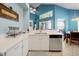 Open kitchen with stainless steel appliances, quartz countertops, breakfast bar, and views to the dining area at 2648 Daulby St, Kissimmee, FL 34747