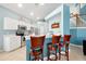 Modern kitchen with white cabinetry, stainless steel appliances, and a breakfast bar for casual dining at 2648 Daulby St, Kissimmee, FL 34747