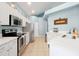 Bright kitchen featuring stainless steel appliances, quartz countertops, and ample white cabinetry at 2648 Daulby St, Kissimmee, FL 34747