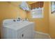 Well-lit laundry room featuring modern washer and dryer units at 2648 Daulby St, Kissimmee, FL 34747