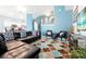 Open-concept living area with blue walls, breakfast bar, and staircase, seamlessly connecting living spaces at 2648 Daulby St, Kissimmee, FL 34747