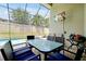 Outdoor pool and patio area with a table set for six, a TV, and comfortable seating for entertaining at 2648 Daulby St, Kissimmee, FL 34747