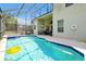 A stunning screened in pool with a patio and outdoor television for fun in the sun at 2648 Daulby St, Kissimmee, FL 34747