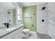 Updated bathroom with marble tile, granite vanity, and modern fixtures at 2736 Shannon Rd, Orlando, FL 32806