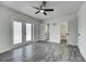 Bright bedroom with ceiling fan, ensuite bath, walk-in closet, and glass panel doors to a private outdoor space at 2736 Shannon Rd, Orlando, FL 32806