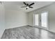 Bedroom featuring neutral paint, modern ceiling fan, and glass panel doors to a private outdoor space at 2736 Shannon Rd, Orlando, FL 32806