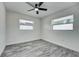 Bedroom featuring neutral paint, modern ceiling fan, and lots of natural light from two windows at 2736 Shannon Rd, Orlando, FL 32806