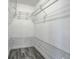 Walk-in closet with shelving and gray wood-look floors at 2736 Shannon Rd, Orlando, FL 32806