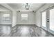 Bright dining room area with new floors, modern lighting and views into the kitchen and living space at 2736 Shannon Rd, Orlando, FL 32806