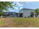 Expansive backyard featuring a screened-in pool and lush green lawn, ideal for outdoor activities and relaxation at 275 Lakeshore Dr, Davenport, FL 33837
