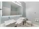 Bright bathroom features a double sink vanity, a large mirror and modern fixtures at 275 Lakeshore Dr, Davenport, FL 33837