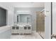 Bright bathroom featuring double sink vanity, modern fixtures and a glass door shower at 275 Lakeshore Dr, Davenport, FL 33837