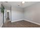 Bright bedroom featuring wood flooring, ceiling fan, and view into hall at 275 Lakeshore Dr, Davenport, FL 33837