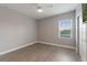 Comfortable bedroom with wood floor, ceiling fan, and bright window at 275 Lakeshore Dr, Davenport, FL 33837