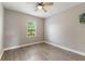 Comfortable bedroom with wood floor, ceiling fan, and window at 275 Lakeshore Dr, Davenport, FL 33837