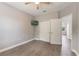 Comfortable bedroom with wood floor, ceiling fan, closet, and TV at 275 Lakeshore Dr, Davenport, FL 33837